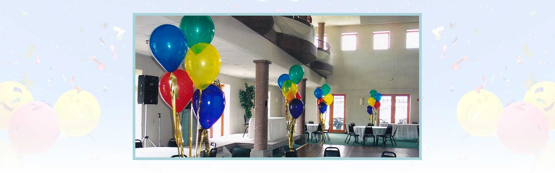 Colorful balloons are tied to tables in a spacious, well-lit room set up for an event or celebration.